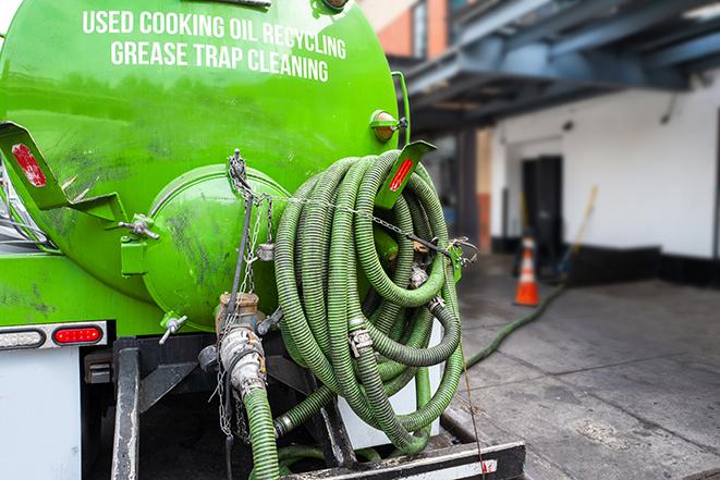 a grease trap pumping truck at a restaurant in Bald Eagle